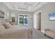 Main bedroom with king bed, access to pool and spa at 5868 Meriwether Pl, Sarasota, FL 34232