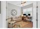 Bright office features a desk, couch, and large clock at 5868 Meriwether Pl, Sarasota, FL 34232