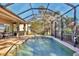 Inviting screened pool and spa with a covered patio and lush landscaping at 5868 Meriwether Pl, Sarasota, FL 34232