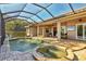 Screened pool and spa with a covered patio and outdoor dining area at 5868 Meriwether Pl, Sarasota, FL 34232