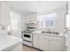 Efficient kitchen featuring white cabinetry and modern appliances at 5902 Garden Ln # A24, Bradenton, FL 34207