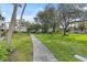 Landscaped grounds with a walkway, lush grass, and mature trees at 5902 Garden Ln # A24, Bradenton, FL 34207