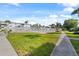 Community pool with surrounding fenced area, lush landscaping, and walkways at 5902 Garden Ln # A24, Bradenton, FL 34207