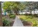 Paved walkway winds through lush tropical landscaping at 5902 Garden Ln # A24, Bradenton, FL 34207