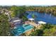 Community pool and spa overlooking a lake, with adjacent buildings at 6307 Walton Heath Pl, University Park, FL 34201