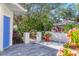 Charming courtyard with blue door and lush plants at 6307 Walton Heath Pl, University Park, FL 34201