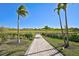 Walkway through landscaped grounds with palm trees at 6324 Plateau Ct, Bradenton, FL 34203