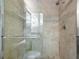 Large walk-in shower with glass enclosure and tile surround at 6451 Elmwood Ave # H, Sarasota, FL 34231