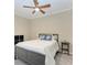 Bedroom with ceiling fan, full bed, and adjacent bathroom at 7015 River Hammock Dr # 203, Bradenton, FL 34212