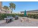 Outdoor grilling area with picnic tables and umbrellas at 711 Beach Rd # 208, Sarasota, FL 34242