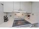 Kitchen boasts a smooth cooktop and ample counter space at 711 Beach Rd # 208, Sarasota, FL 34242