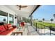 Covered back patio overlooking the water, outdoor kitchen, and comfortable seating at 7418 Westmoreland Dr, Sarasota, FL 34243
