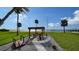Relaxing backyard patio with pergola, seating area, and waterfront views at 7418 Westmoreland Dr, Sarasota, FL 34243