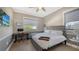 Comfortable bedroom with a queen-size bed, built-in desk, and plenty of natural light at 7418 Westmoreland Dr, Sarasota, FL 34243