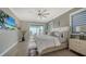 Bright bedroom with king-size bed, sliding doors to balcony, and water view at 7418 Westmoreland Dr, Sarasota, FL 34243