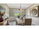 Bright dining room with large windows, hardwood floors, and elegant chandelier at 7418 Westmoreland Dr, Sarasota, FL 34243