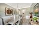 Bright dining room with large windows, hardwood floors, and elegant chandelier at 7418 Westmoreland Dr, Sarasota, FL 34243