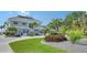 Two story home with gray siding, metal roof, and landscaped yard at 7418 Westmoreland Dr, Sarasota, FL 34243