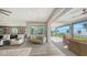Bright living room with water views, comfortable seating, and access to deck at 7418 Westmoreland Dr, Sarasota, FL 34243