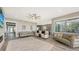 Living room features hardwood floors, comfortable seating, and views of kitchen at 7418 Westmoreland Dr, Sarasota, FL 34243