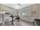 Bright office with standing desk, hardwood floors, and large windows at 7418 Westmoreland Dr, Sarasota, FL 34243