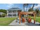 Firepit area with wooden pergola and comfortable seating at 7418 Westmoreland Dr, Sarasota, FL 34243