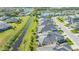 Aerial view of home showcasing backyard lanai and canal view at 7525 Alumni Trl, Sarasota, FL 34243