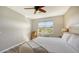 Spacious bedroom with king bed, window, and wood-look flooring at 7525 Alumni Trl, Sarasota, FL 34243