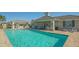 Inviting community pool with patio and covered seating area at 7525 Alumni Trl, Sarasota, FL 34243