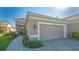 Home exterior featuring a two-car garage and walkway at 7525 Alumni Trl, Sarasota, FL 34243