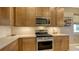 Modern kitchen with stainless steel appliances and wood cabinets at 7525 Alumni Trl, Sarasota, FL 34243