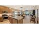 Open kitchen with island, stainless steel appliances, and wood cabinets at 7525 Alumni Trl, Sarasota, FL 34243