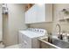 Laundry room with washer, dryer, and utility sink at 7525 Alumni Trl, Sarasota, FL 34243