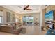 Living room with leather couch, fireplace, and view of the patio at 7525 Alumni Trl, Sarasota, FL 34243