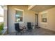 Covered patio with two chairs and small table at 7525 Alumni Trl, Sarasota, FL 34243