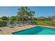 Community pool with lounge chairs and a fenced area at 7525 Alumni Trl, Sarasota, FL 34243