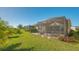 Covered patio with seating area and lush landscaping at 7525 Alumni Trl, Sarasota, FL 34243