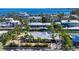 Aerial view of waterfront home with boat dock and lush landscaping at 834 Jungle Queen Way, Longboat Key, FL 34228