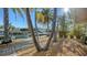 Landscaped backyard with wooden walkway to the dock at 834 Jungle Queen Way, Longboat Key, FL 34228