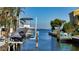 Covered boat dock with a lift and a Jet Ski at 834 Jungle Queen Way, Longboat Key, FL 34228