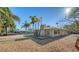 Charming single-story home with a stone chimney and tropical landscaping at 834 Jungle Queen Way, Longboat Key, FL 34228