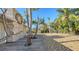 Landscaped front yard with palm trees and a stone pathway at 834 Jungle Queen Way, Longboat Key, FL 34228