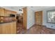 Kitchen entry with wood cabinets, tile floor, and wood door at 834 Jungle Queen Way, Longboat Key, FL 34228