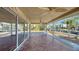 Spacious screened porch with tile floor and ceiling fans at 834 Jungle Queen Way, Longboat Key, FL 34228