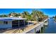 Waterfront view of home with private dock and access to the water at 834 Jungle Queen Way, Longboat Key, FL 34228