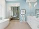 Elegant bathroom with double vanity, soaking tub, and walk-in shower at 9224 Starry Night Ave, Sarasota, FL 34241