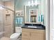 Modern bathroom with a glass shower, vanity, and toilet at 9224 Starry Night Ave, Sarasota, FL 34241