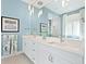 Modern bathroom with double vanity and a large mirror at 9224 Starry Night Ave, Sarasota, FL 34241