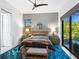 Guest bedroom with a queen bed and sliding glass doors leading to the backyard at 9224 Starry Night Ave, Sarasota, FL 34241