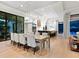 Large dining room with a long table and view into kitchen and living room at 9224 Starry Night Ave, Sarasota, FL 34241